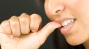 Close-up of woman biting her nails