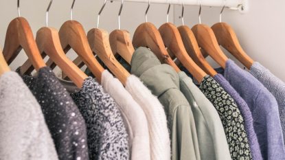 Spring clothes on hangers in a white closet