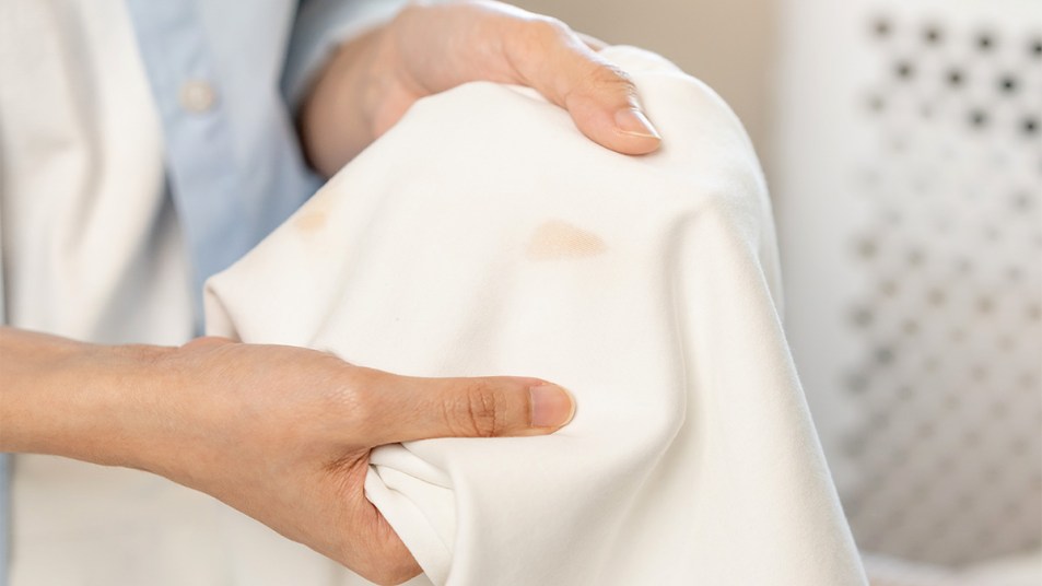 Woman holding a stained white shirt