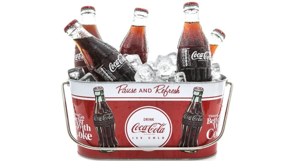 classic Coca Cola glass bottles in a coca cola bucket