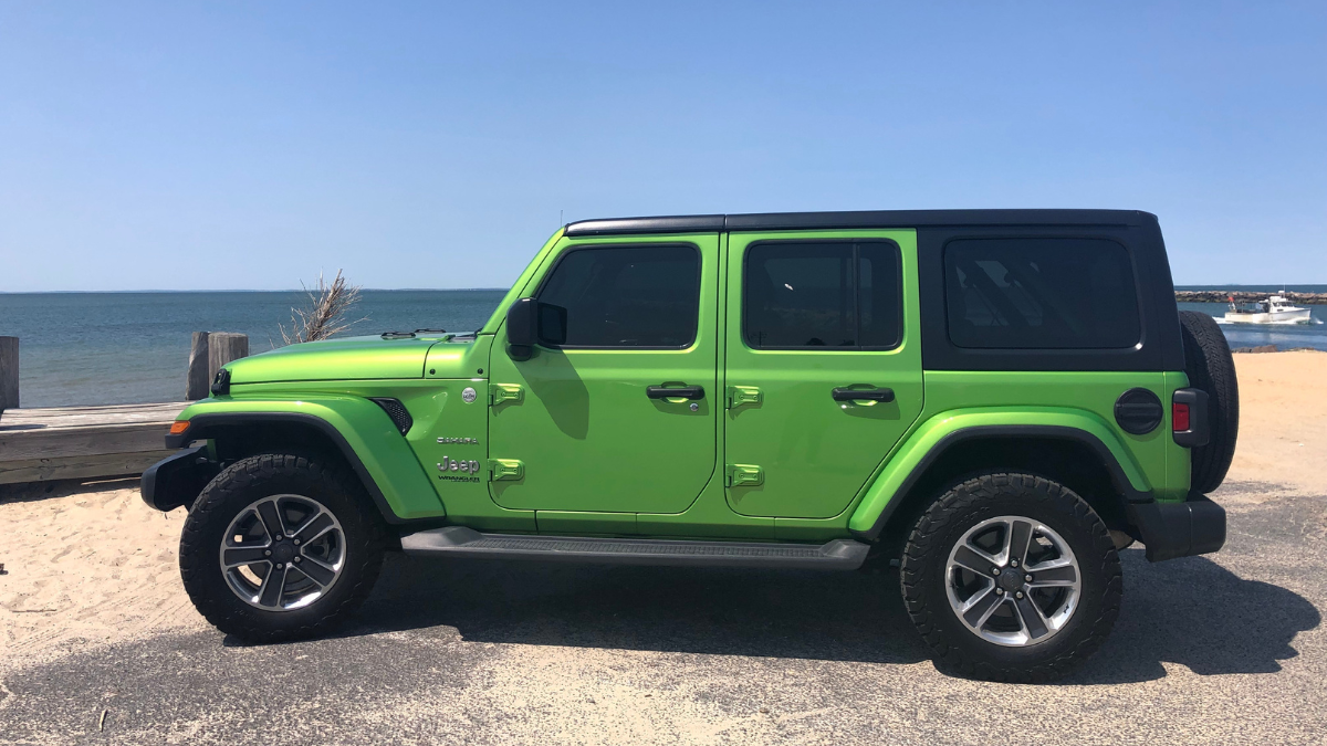 green jeep wrangler by the sea