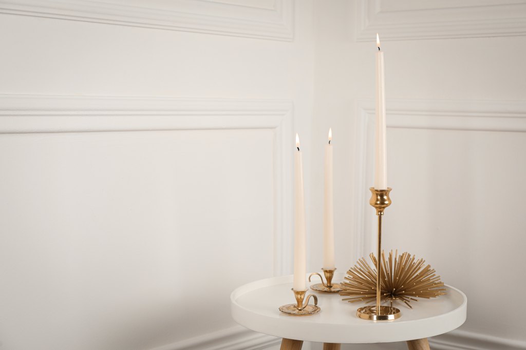 Elegant,Candlesticks,With,Burning,Candles,On,White,Table.,Space,For
