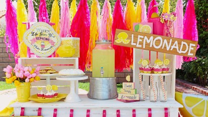 party table displaying lemonade for a crowd, party treats and treats