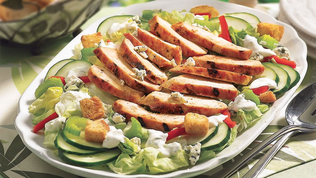 Buffalo chicken on top of salad greens