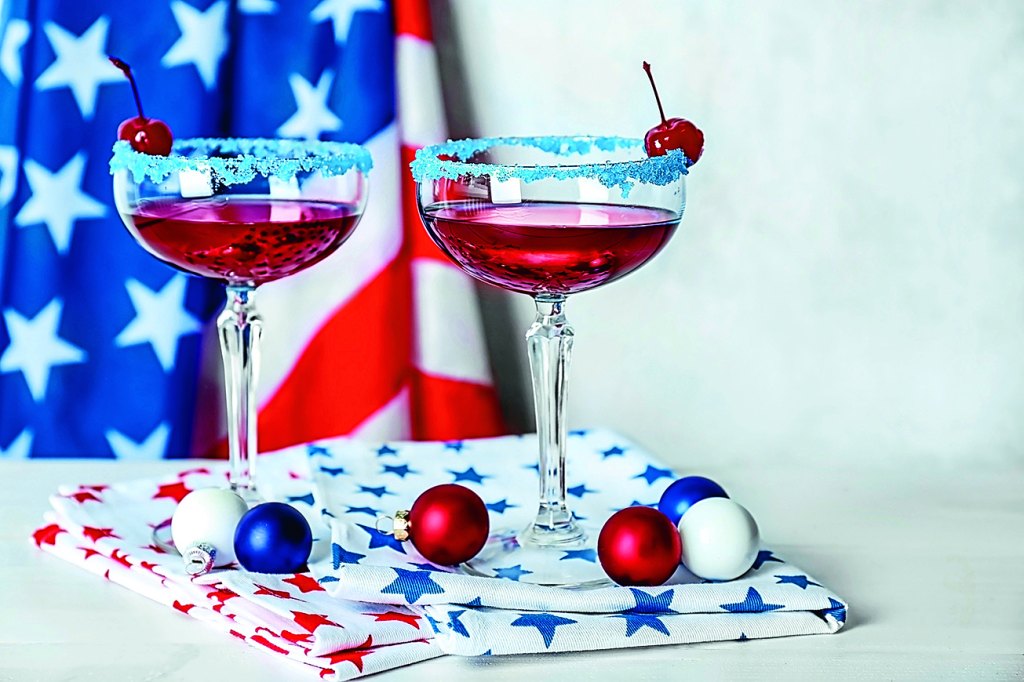 Layered cocktails in colors of American flag on table