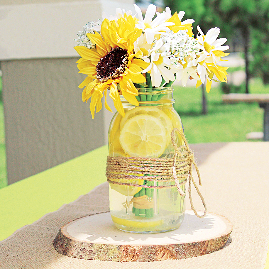 Sunflower and lemon vase display at sunflower party