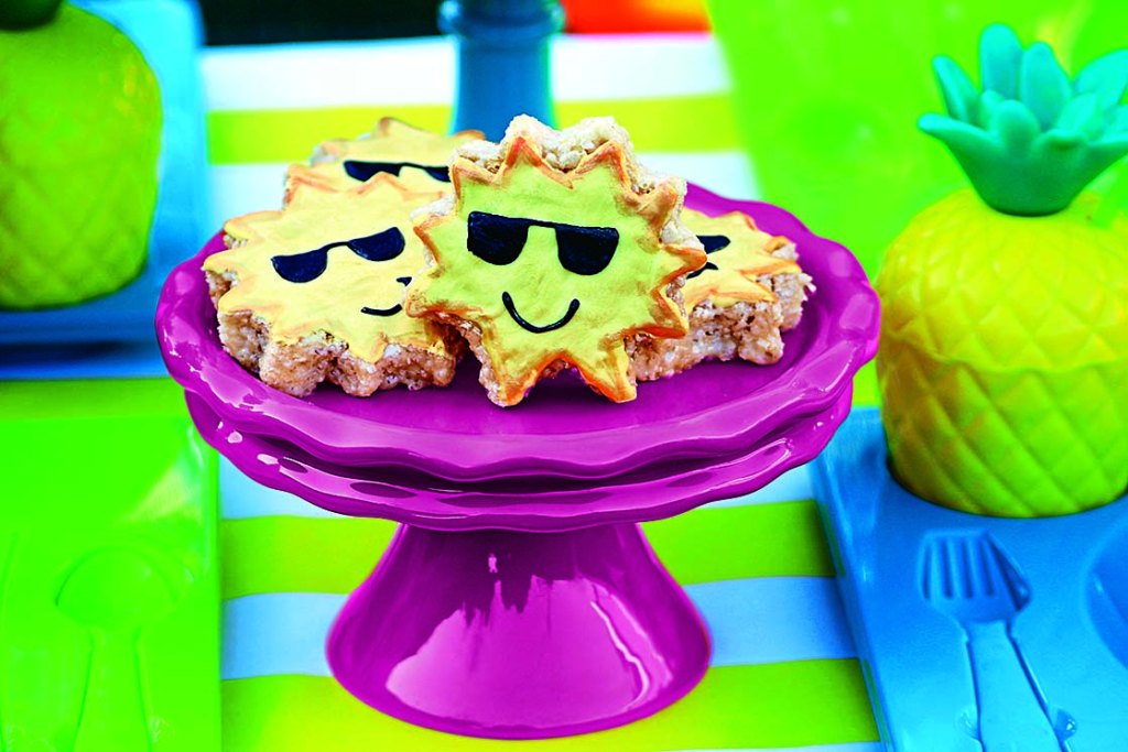Marshmallow rice sweet treat desserts shaped like suns with sunglasses served on a pink pedestal dish