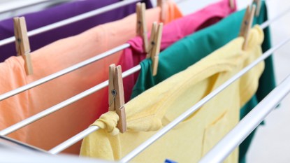 Bright clothes on a rack drying indoors