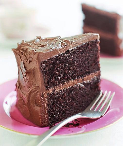 Chocolate Fudge Cake recipe, sits on a pink table cloth 