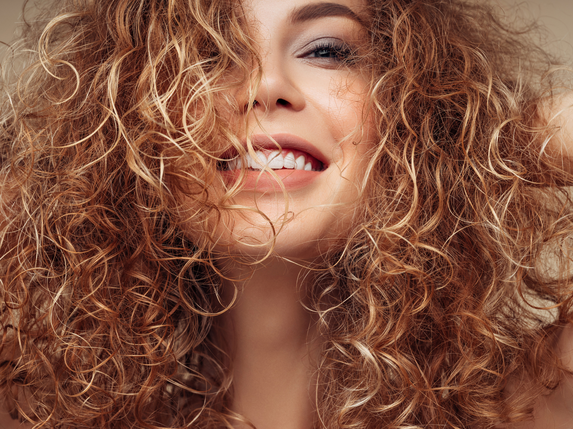 Woman with bouncy, curly brunette hair