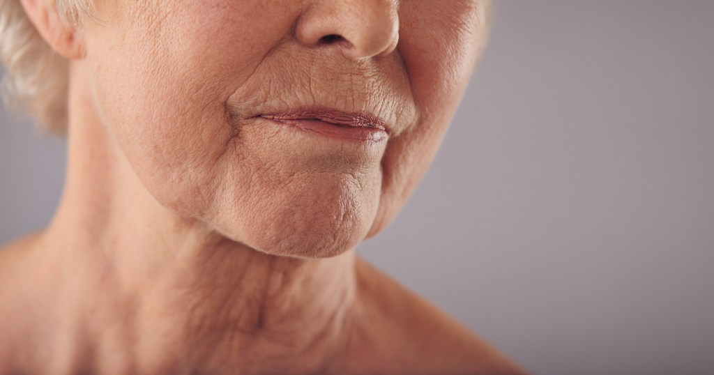 Close-up of mature woman with crepey neck.