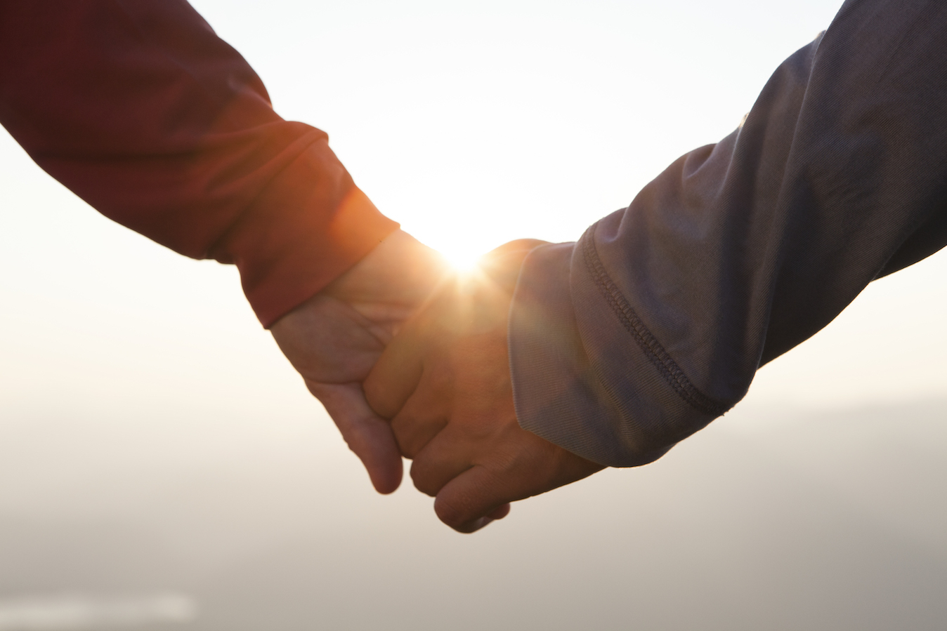 Couple hand in hand at sunset (Capricorn and Pisces Compatibility) 