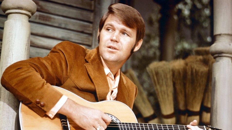 Glen Campbell playing songs on his guitar