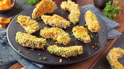 Fried Avocado Wedges sits on a black plate (air fryer appetizers)
