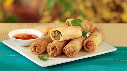 Vegetable Spring Rolls sits on a white plate(air fryer appetizers)