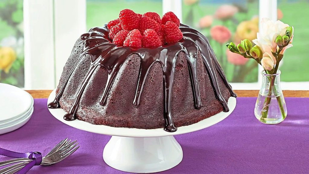 Raspberry Chocolate Bundt Cake sits on a purple table cloth