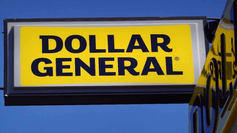 How to save money shopping at Dollar General: : A sign hangs above a Dollar General