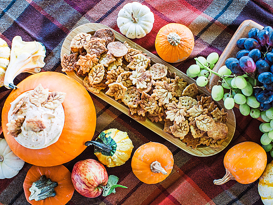 Fall picnic ideas: Homemade pumpkin dip served in hollowed out pumpkin placed alongside tray of biscuits for dipping