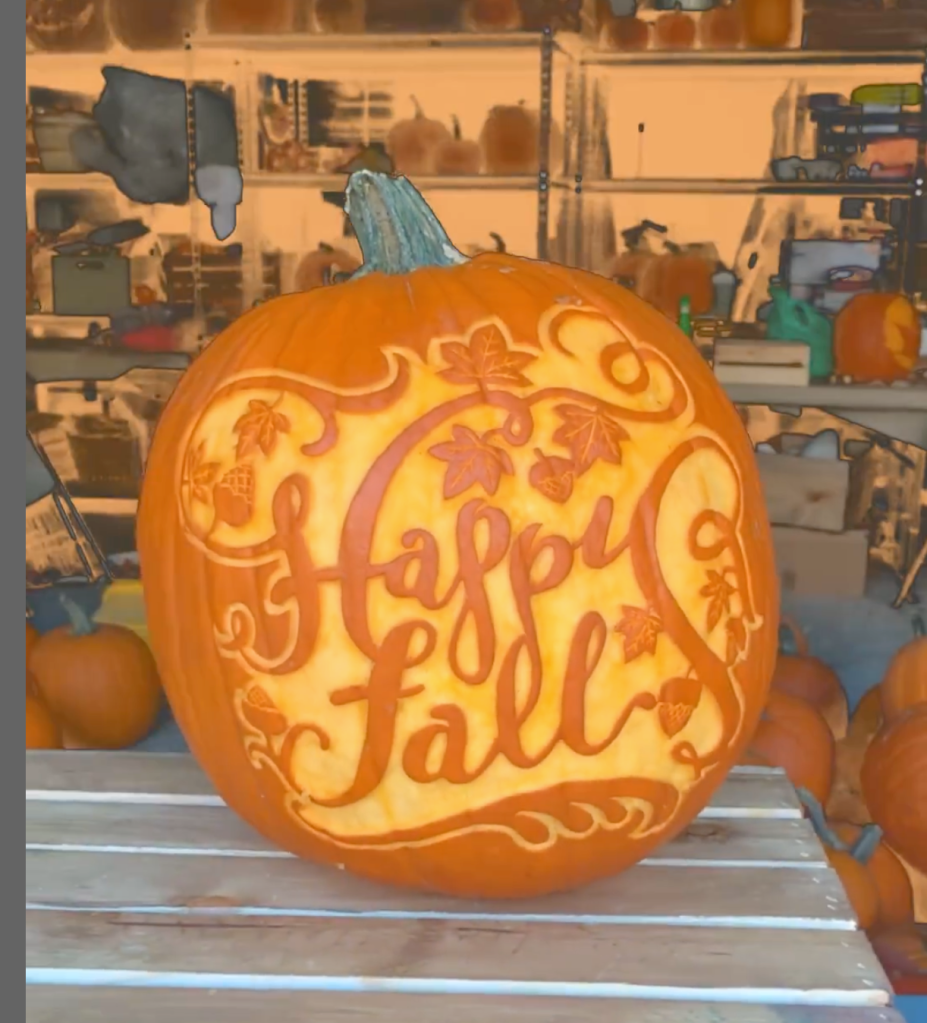 carved pumpkin with the words happy fall