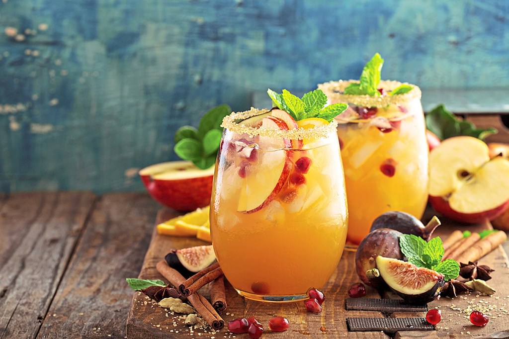 Dessert party: autumn sangria served in glasses and garnished with apples and mint