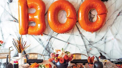 Adult Halloween Party: Lead Halloween Table with orange letter balloons behind table that say "Boo" and snacks and festive treats on table