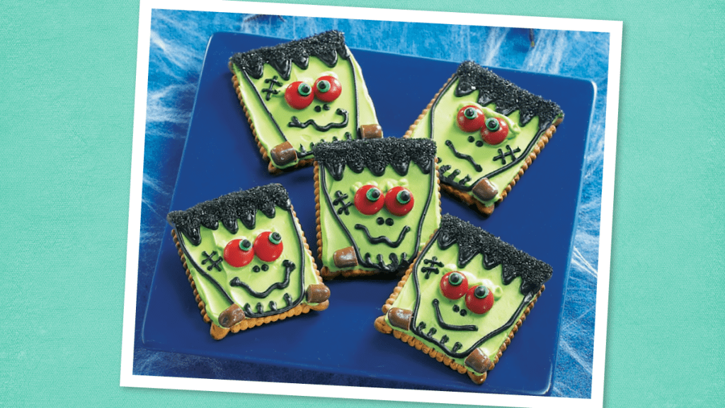 Frankenstein Cookies sits on a blue plate (Halloween Cookies)