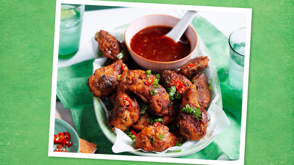 Spicy-Sweet Chicken Wings sits on a white plate ( Game day slow cooker recipes)