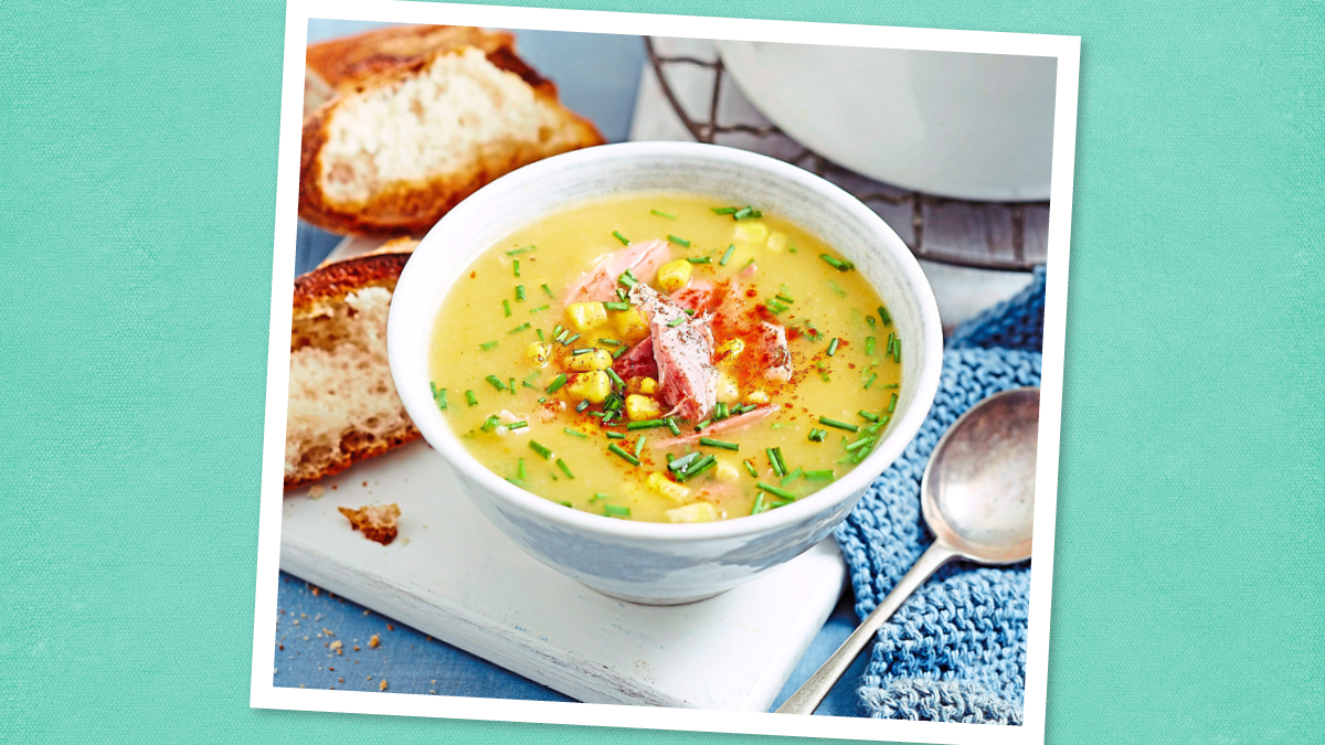 Baked Potato Soup sits in a white bowl (game day slow cooker recipes)