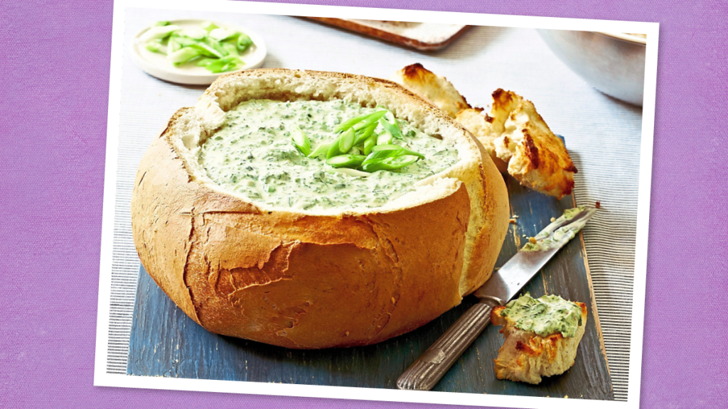 Cheesy Spinach Artichoke Dip sits looking yummy ( Game day slow cooker recipes)