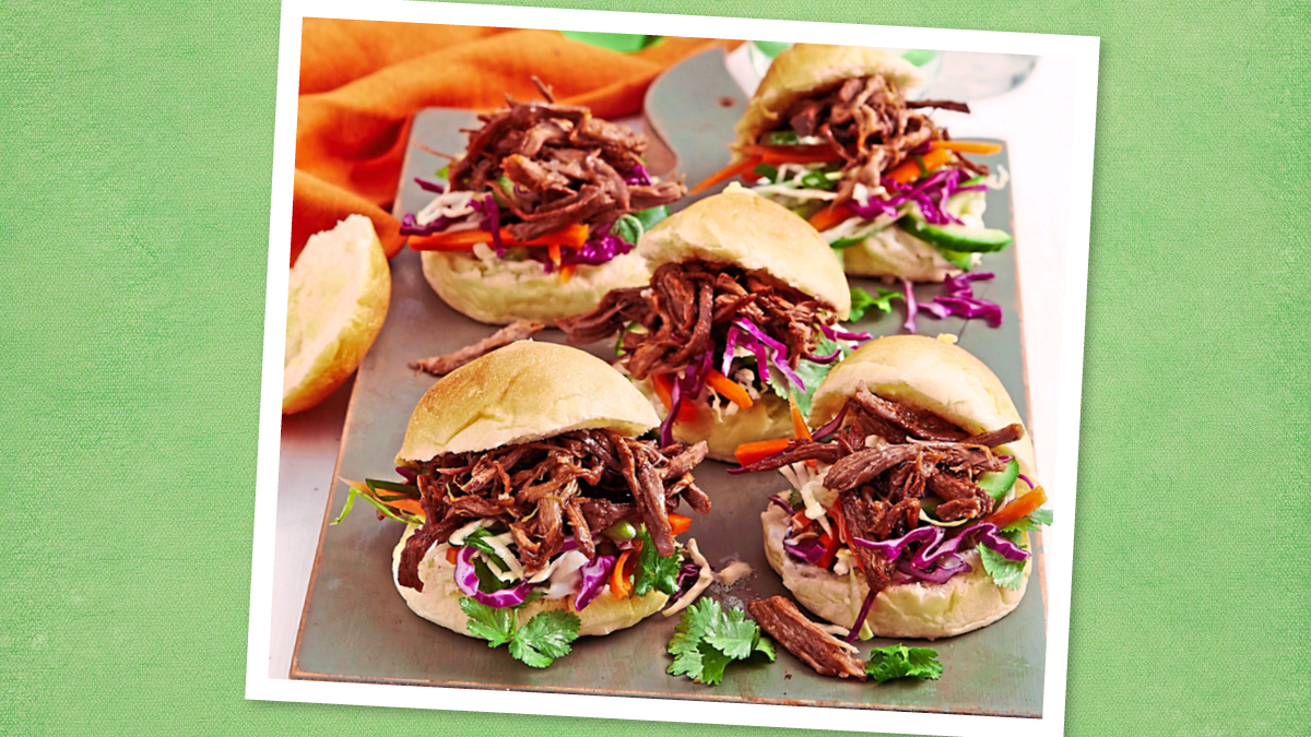 Slow-Cooker Pulled Pork Sliders sits on a plate (game day slow cooker recipes)