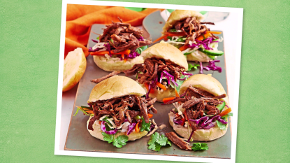 Slow-Cooker Pulled Pork Sliders sits on a plate (game day slow cooker recipes)