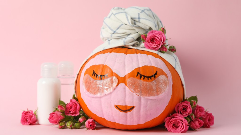 Pumpkin face painted and decorated to look like woman at the spa.