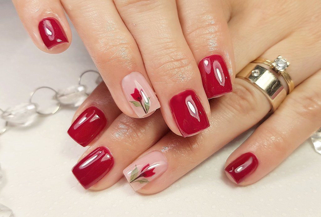 Red nails with one nail painted as a tulip.