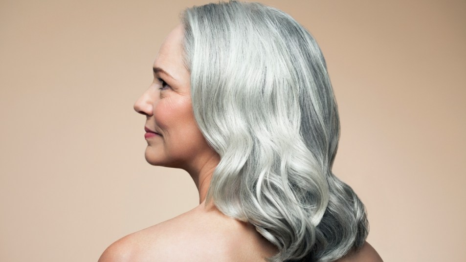 Mature woman with beautiful gray hair looking to the side.