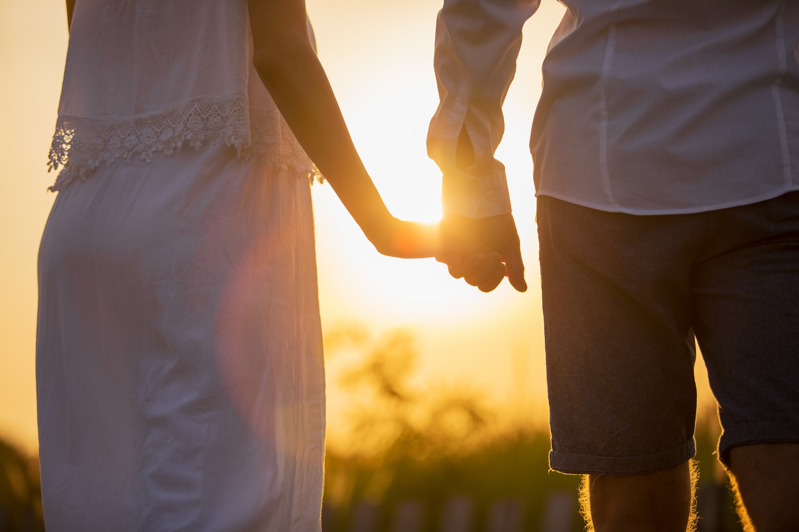 Couple holding hands at sunset (Aquarius and Sagittarius Compatibility) 
