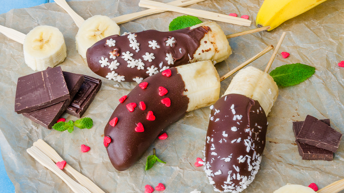 dark chocolate banana pops recipe on table with multicolored sprinkles