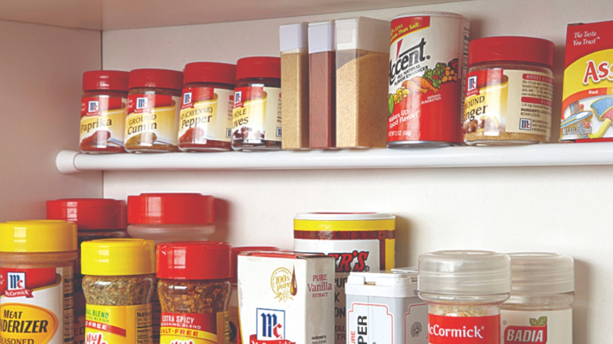 spices in the pantry on tension rod