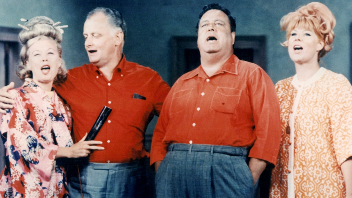 Joyce Randolph, US actress, Art Carney (1918-2003), US actor, Jackie Gleason (1916-1987), US actor, and Audrey Meadows (1922-1996), US actress, stand in a group singing in an image issued publicity for the television series, 'The Honeymooners', USA, circa 1955.