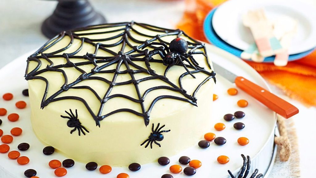 Spiderweb Cake sits on a white plate (halloween cakes)