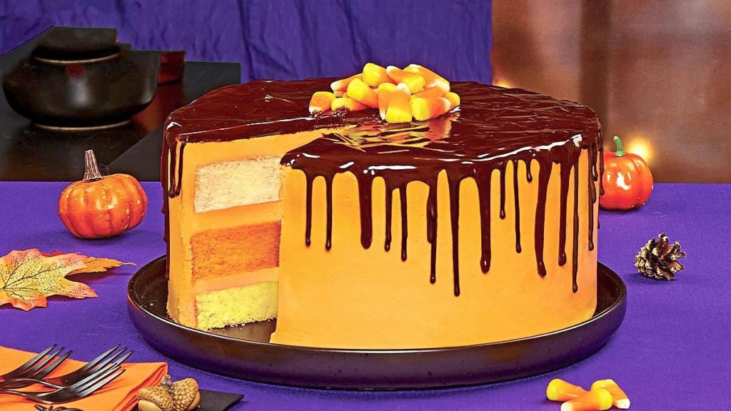 Glazed Candy Corn Cake sits on a black plate (halloween cakes)
