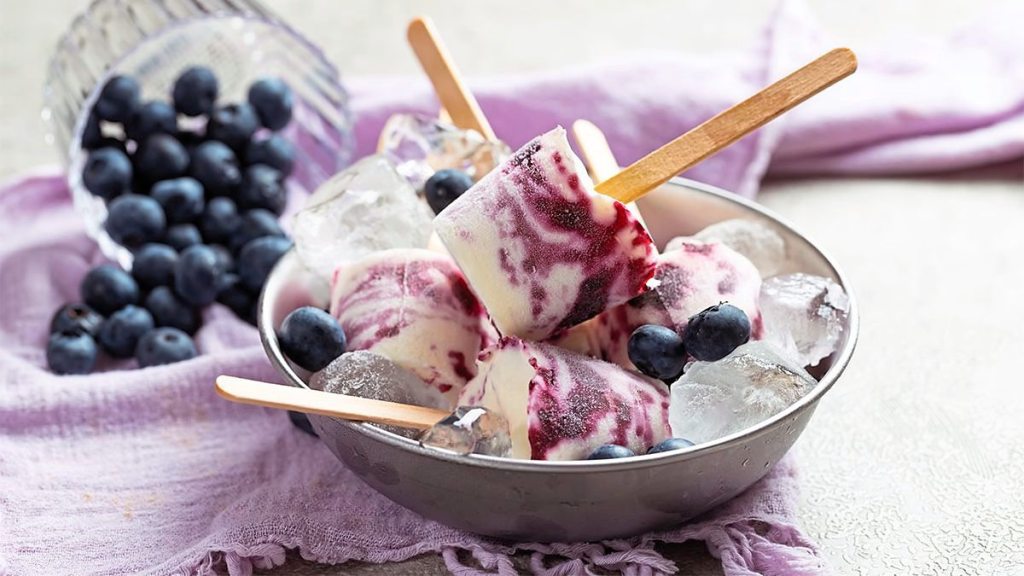 Blueberry-Banana Pops sits next to some blueberries (5 minute desserts)
