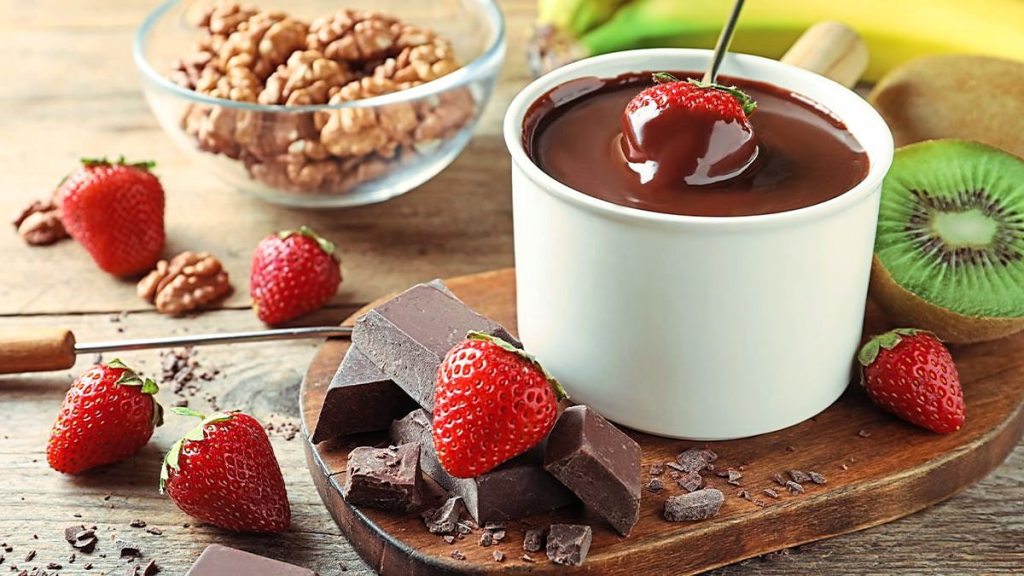 Dark Chocolate Dreamy Fondue sits next to some fruit (5 minute desserts)