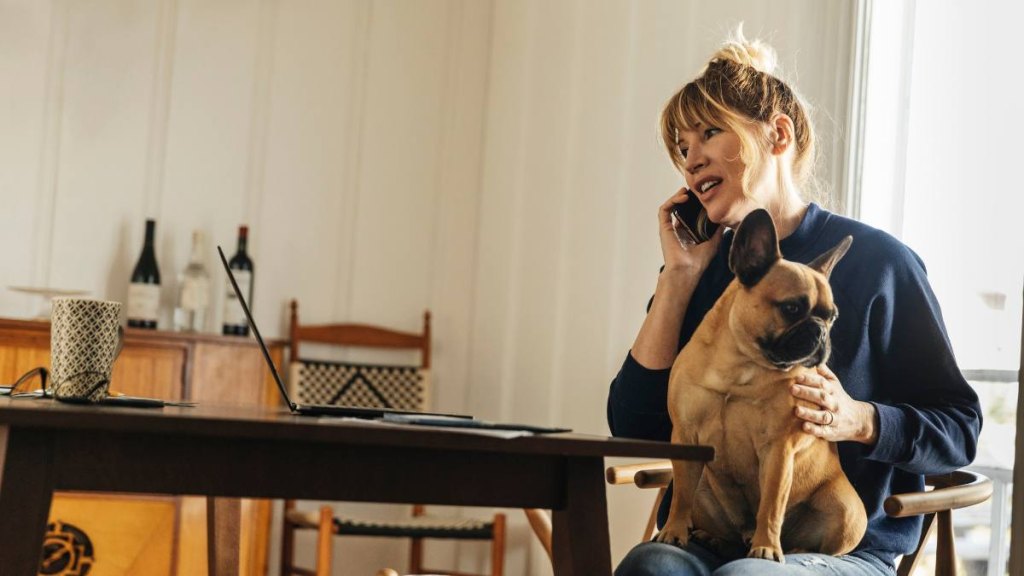 Woman working at home with dog