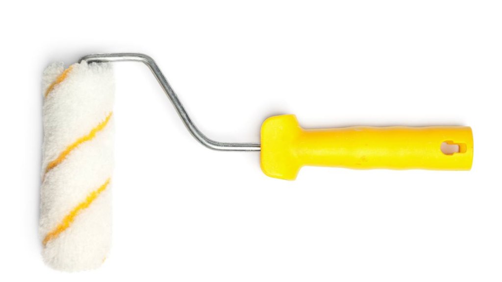 how to clean kitchen cabinets: a yellow paint roller