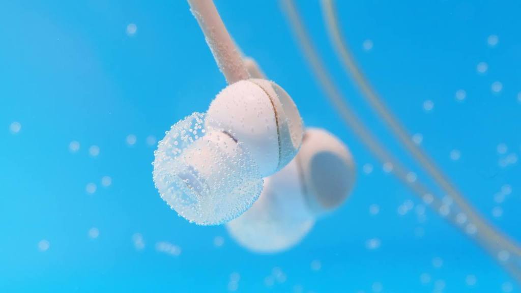 How to clean headphones: Underwater headphones Close up. Underwater, selective focus. music concept