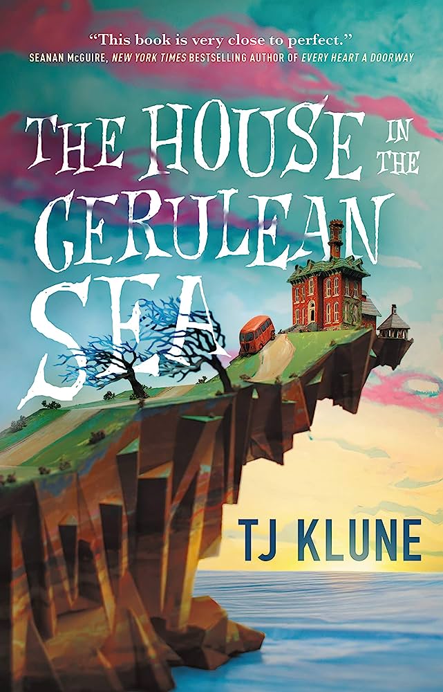 Found family trope: The House in the Cerulean Sea by T.J Klune shows a book cover with a magical house sitting on the edge of a cliffside over water