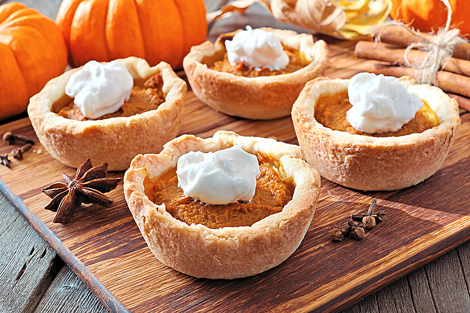 Pie party: Mini pumpkin pie tartlets served on a wooden tray