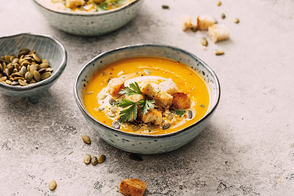 Friendsgiving: Pumpkin soup in a bowl on tabletop