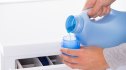 how much laundry detergent to use: Woman Pouring Detergent With Washing Machine In Background