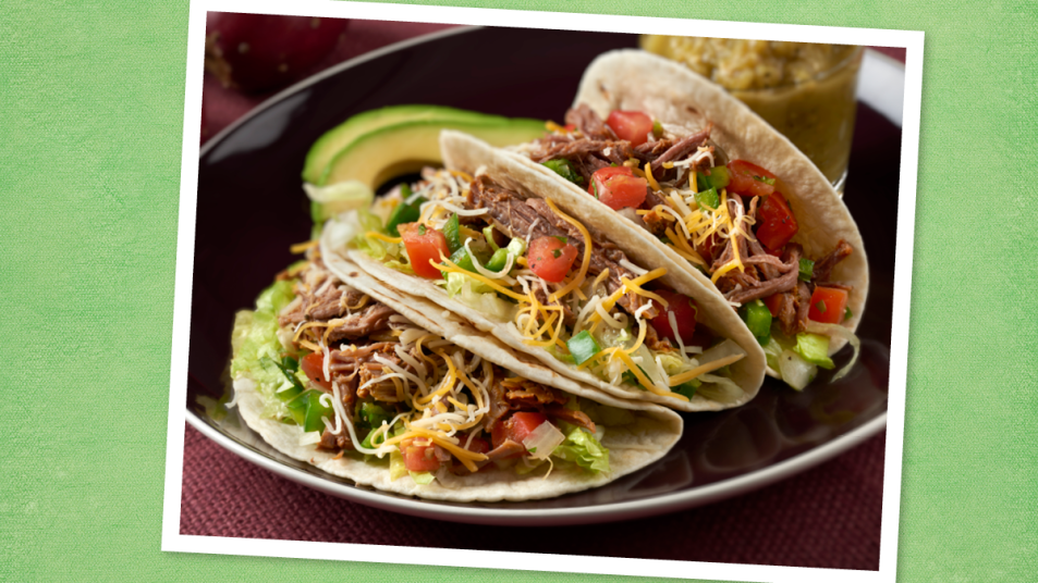 Barbacoa Beef Tacos sits on a green background (taco tuesday recipes)